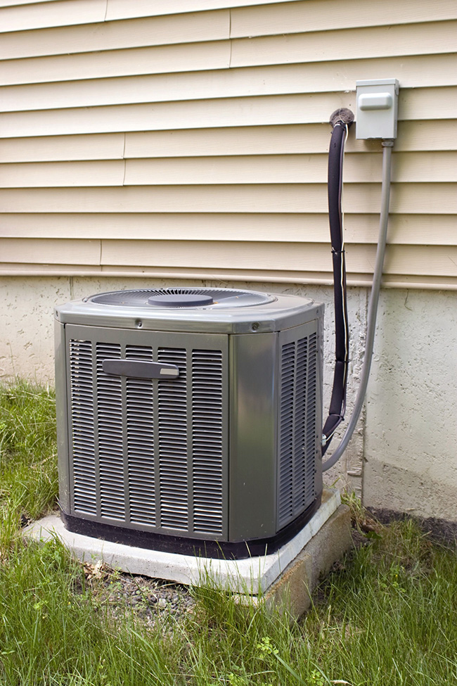 A residential central air conditioning unit sitting outside a home